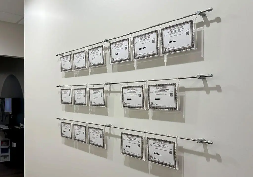 R2021 — Certificate Wall Displays with Hook-On Acrylic Frames Mounted to Wall with Horizontal Rod System