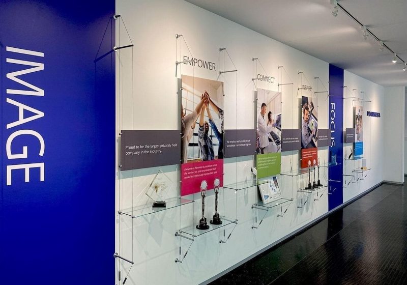 C1035 — Cable Suspended Recognition Wall Display with Graphics, Signage and Shelves