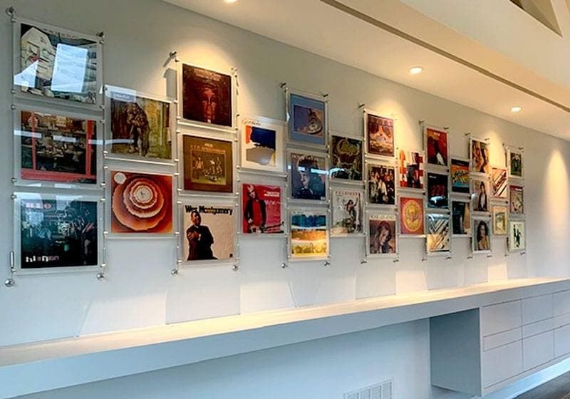 cable-suspended-magazine-and-vinyl-records-display-with-frosted-acrylic-frames